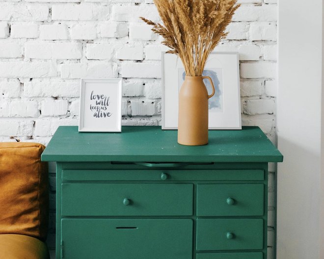 green drawers with vase on top